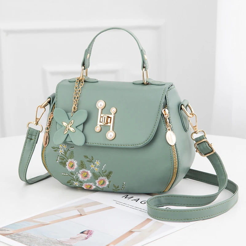 EMBROIDERED STRUCTURED TOP‑HANDLE CROSSBODY