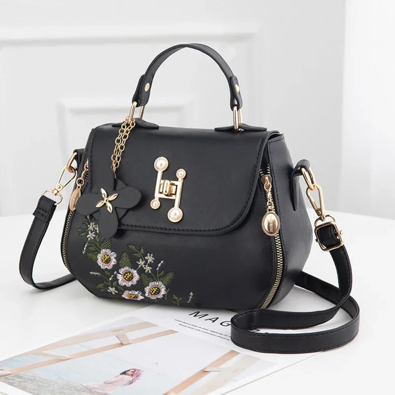 EMBROIDERED STRUCTURED TOP‑HANDLE CROSSBODY