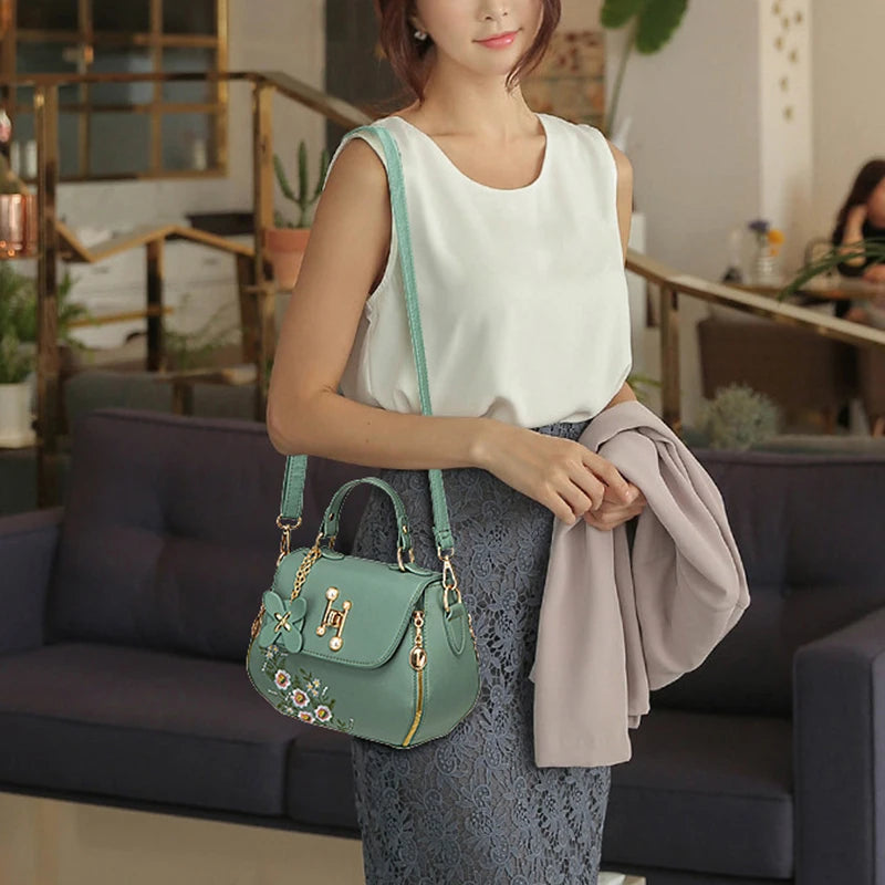 EMBROIDERED STRUCTURED TOP‑HANDLE CROSSBODY