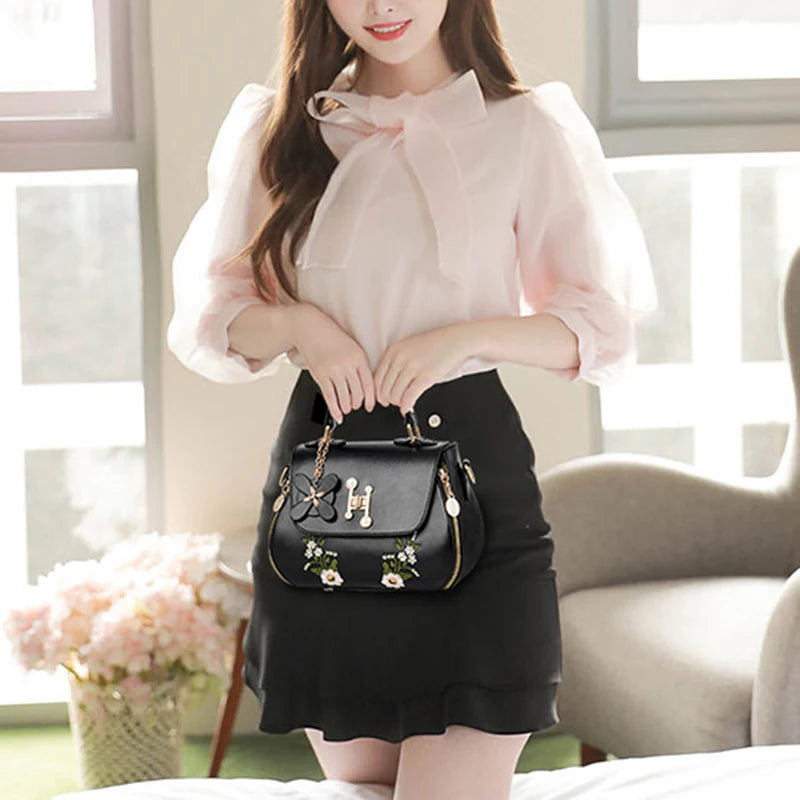 EMBROIDERED STRUCTURED TOP‑HANDLE CROSSBODY